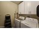 Well-equipped laundry room with washer, dryer and storage cabinets at 650 N Hawes Rd # 4326, Mesa, AZ 85207