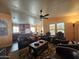 Open-concept living room featuring hardwood floors, a ceiling fan, and plenty of natural light at 650 N Hawes Rd # 4326, Mesa, AZ 85207