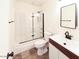 Bathroom with tub-shower combo, neutral walls, sink, toilet and mirror at 6847 S Willow Dr, Tempe, AZ 85283