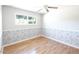 Bedroom with light blue walls, wainscotting and wood floor at 6847 S Willow Dr, Tempe, AZ 85283