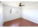 Bright bedroom featuring hardwood floors, a ceiling fan and window at 6847 S Willow Dr, Tempe, AZ 85283