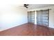 Neutral bedroom featuring sliding barn doors, white walls, and a large ceiling fan with light at 6847 S Willow Dr, Tempe, AZ 85283