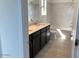 Well-lit bathroom featuring a marble-style backsplash, dark cabinets, and modern fixtures at 7208 E Purple Prairie Dr, San Tan Valley, AZ 85143