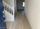 Inviting entryway featuring neutral tile flooring and a staircase with white posts and handrail at 7208 E Purple Prairie Dr, San Tan Valley, AZ 85143