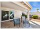 Covered patio featuring tile flooring with a table and two chairs, and a sliding glass door leading to the interior at 7214 N Via De La Siesta --, Scottsdale, AZ 85258