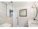 Bathroom featuring tub with marble tile surround and modern fixtures at 7309 E Rovey Ave, Scottsdale, AZ 85250