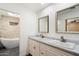 Bright bathroom featuring a double sink vanity with marble countertop and modern fixtures at 7309 E Rovey Ave, Scottsdale, AZ 85250