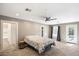 Spacious bedroom featuring plush carpeting, ceiling fan, and access to the outdoors at 7309 E Rovey Ave, Scottsdale, AZ 85250