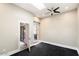 Bright bedroom featuring dark floors, modern ceiling fan, and access to the outdoors at 7309 E Rovey Ave, Scottsdale, AZ 85250