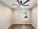 Cozy bedroom with wood-look flooring and a window offering natural light at 7309 E Rovey Ave, Scottsdale, AZ 85250