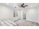 Bedroom with plush carpeting, ceiling fan, and bright natural light at 7309 E Rovey Ave, Scottsdale, AZ 85250