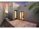 Private courtyard features iron table set, pavers, decorative rock, and access from large sliding glass doors at 7309 E Rovey Ave, Scottsdale, AZ 85250