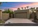 Desert home features an attached two-car garage, mature desert landscaping, and beautiful desert sunset at 7309 E Rovey Ave, Scottsdale, AZ 85250