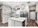 Beautiful kitchen with stainless steel appliances, chic light fixtures, and designer tile backsplash at 7309 E Rovey Ave, Scottsdale, AZ 85250