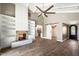 Spacious living room featuring a fireplace, built-in shelving, and wood-look tile flooring at 7309 E Rovey Ave, Scottsdale, AZ 85250