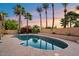 Inviting pool area with mature palm trees, lush landscaping, and refreshing cool blue water at 7309 E Rovey Ave, Scottsdale, AZ 85250