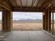 Framing construction looking out the back of the house to the block fence and desert landscape at 9548 W Parkway Dr, Tolleson, AZ 85353