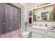 This bathroom has a framed mirror and a shower with floral curtain at 9625 W Oak Ridge Dr, Sun City, AZ 85351