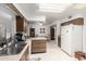 Bright kitchen features wooden cabinets and a sink under a window that overlooks the front yard at 9625 W Oak Ridge Dr, Sun City, AZ 85351