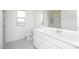 Bathroom featuring a white vanity with storage and a large mirror in a well-lit space at 9819 W Agora Ln, Tolleson, AZ 85353