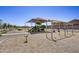 Inviting neighborhood playground, shaded and equipped with swings and climbing structures at 9819 W Agora Ln, Tolleson, AZ 85353