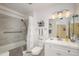 An updated bathroom featuring tile surround, modern vanity, and coordinated fixtures at 10443 W Loma Blanca Dr, Sun City, AZ 85351