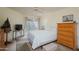 Bright bedroom with a queen bed, sliding glass doors to a patio, and ample closet space at 10443 W Loma Blanca Dr, Sun City, AZ 85351