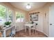 Cozy breakfast nook with white table and chairs, bright natural light, and tile flooring at 10443 W Loma Blanca Dr, Sun City, AZ 85351