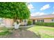 Charming home with manicured lawn and mature tree shading the entrance at 10443 W Loma Blanca Dr, Sun City, AZ 85351