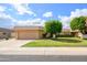 Charming single-story home featuring a well-manicured lawn and mature trees at 10443 W Loma Blanca Dr, Sun City, AZ 85351