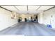 Spacious garage with ample storage cabinets, a clean floor, and plenty of room for parking and projects at 10443 W Loma Blanca Dr, Sun City, AZ 85351