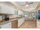 Bright kitchen with white cabinets, stainless steel appliances, and a cozy breakfast nook at 10443 W Loma Blanca Dr, Sun City, AZ 85351