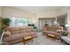 Bright living room with neutral walls, plush couches, and large windows for natural light at 10443 W Loma Blanca Dr, Sun City, AZ 85351