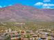 Wonderful aerial view featuring desert homes nestled against a mountain backdrop and picturesque desert landscape at 10649 E Saddle Blanket Trl, Gold Canyon, AZ 85118