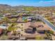 Aerial view of desert homes featuring well manicured yards and community amenities such as swimming pools at 10649 E Saddle Blanket Trl, Gold Canyon, AZ 85118