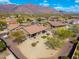 Aerial view of a desert home with patio seating and landscaping that offers beautiful desert mountain views at 10649 E Saddle Blanket Trl, Gold Canyon, AZ 85118