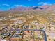 Expansive aerial view captures the desert landscape surrounding this beautiful home and its neighborhood at 10649 E Saddle Blanket Trl, Gold Canyon, AZ 85118