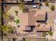 Aerial view of a home with desert landscaping, cozy patio, and a built-in firepit with chairs at 10649 E Saddle Blanket Trl, Gold Canyon, AZ 85118