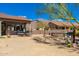 Outdoor kitchen and dining with desert landscape and mountain views from the covered patio at 10649 E Saddle Blanket Trl, Gold Canyon, AZ 85118
