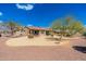 Spacious backyard with desert landscaping, mature trees, and a well-maintained lawn at 10649 E Saddle Blanket Trl, Gold Canyon, AZ 85118