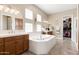 Bright bathroom features a large soaking tub, double vanities, and a walk-in closet at 10649 E Saddle Blanket Trl, Gold Canyon, AZ 85118