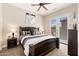 Comfortable bedroom with carpet and large bed, with backyard views from the French doors at 10649 E Saddle Blanket Trl, Gold Canyon, AZ 85118