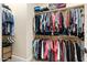 Spacious walk-in closet features ample hanging storage, shelving and neutral carpeting at 10649 E Saddle Blanket Trl, Gold Canyon, AZ 85118