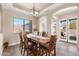 Dining room featuring a wooden table set with modern light fixture and door to the outside at 10649 E Saddle Blanket Trl, Gold Canyon, AZ 85118