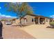 Side view of home with rock landscaping, mature trees, and a well-maintained yard at 10649 E Saddle Blanket Trl, Gold Canyon, AZ 85118