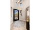 Elegant foyer featuring a wrought iron front door and arched doorways at 10649 E Saddle Blanket Trl, Gold Canyon, AZ 85118
