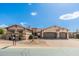 Stunning single-story home featuring a stone facade, three-car garage, and desert landscaping at 10649 E Saddle Blanket Trl, Gold Canyon, AZ 85118