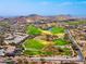 Scenic aerial view of a picturesque golf course nestled amidst desert homes and rolling hills at 10649 E Saddle Blanket Trl, Gold Canyon, AZ 85118