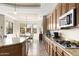 Open kitchen with granite countertops and stainless steel appliances flows into the dining area at 10649 E Saddle Blanket Trl, Gold Canyon, AZ 85118