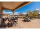 Outdoor patio featuring covered seating area, desert landscaping and blue skies at 10649 E Saddle Blanket Trl, Gold Canyon, AZ 85118